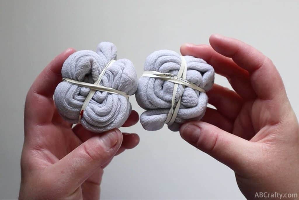 white socks in a spiral with two perpendicular rubber bands