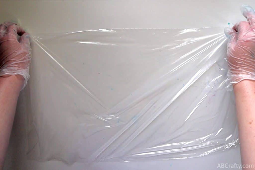 placing plastic wrap onto a white table