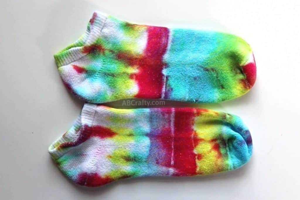 rainbow tie dye socks with more vibrant colors at the toe that fade to more white at the heel