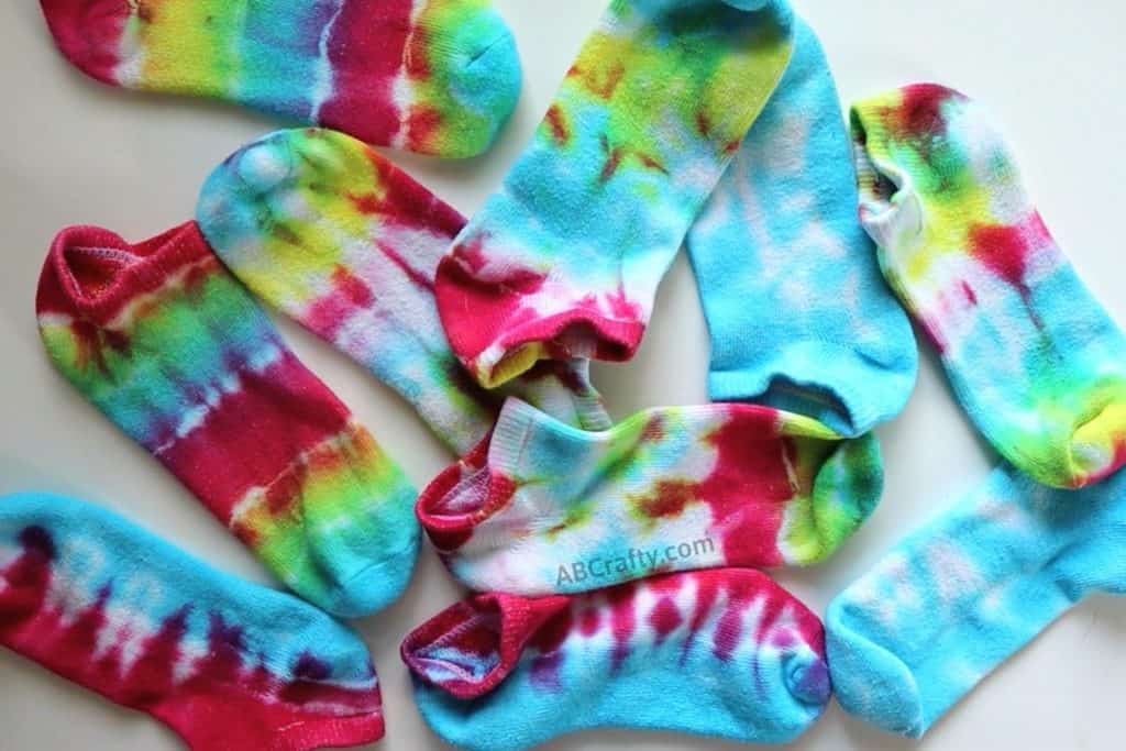 pile of tie dye socks in different colors