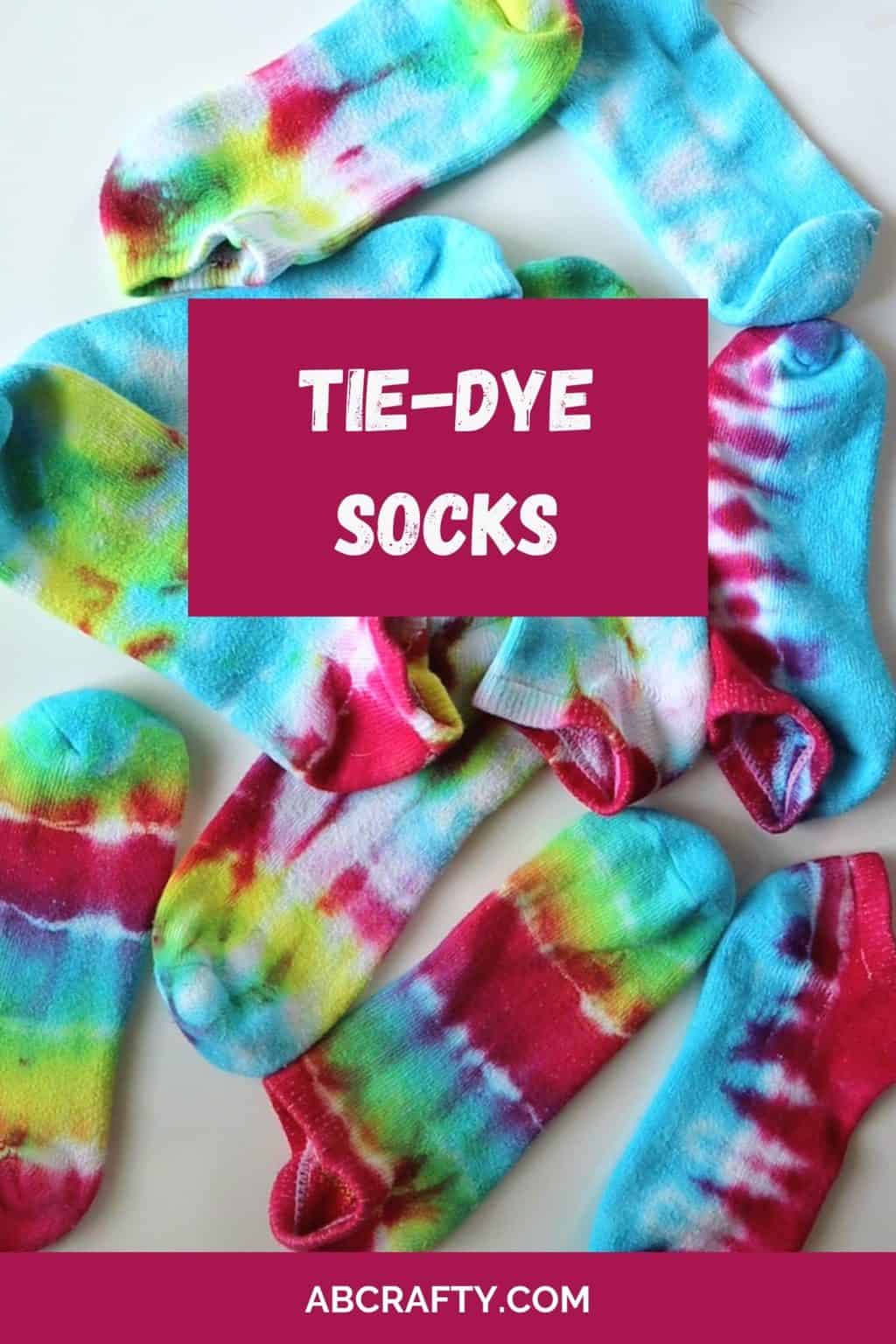 pile of single tie dye socks in different colors with the title tie-dye socks and abcrafty.com