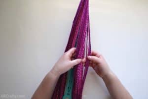 counting pink yarn by separating it with fingers