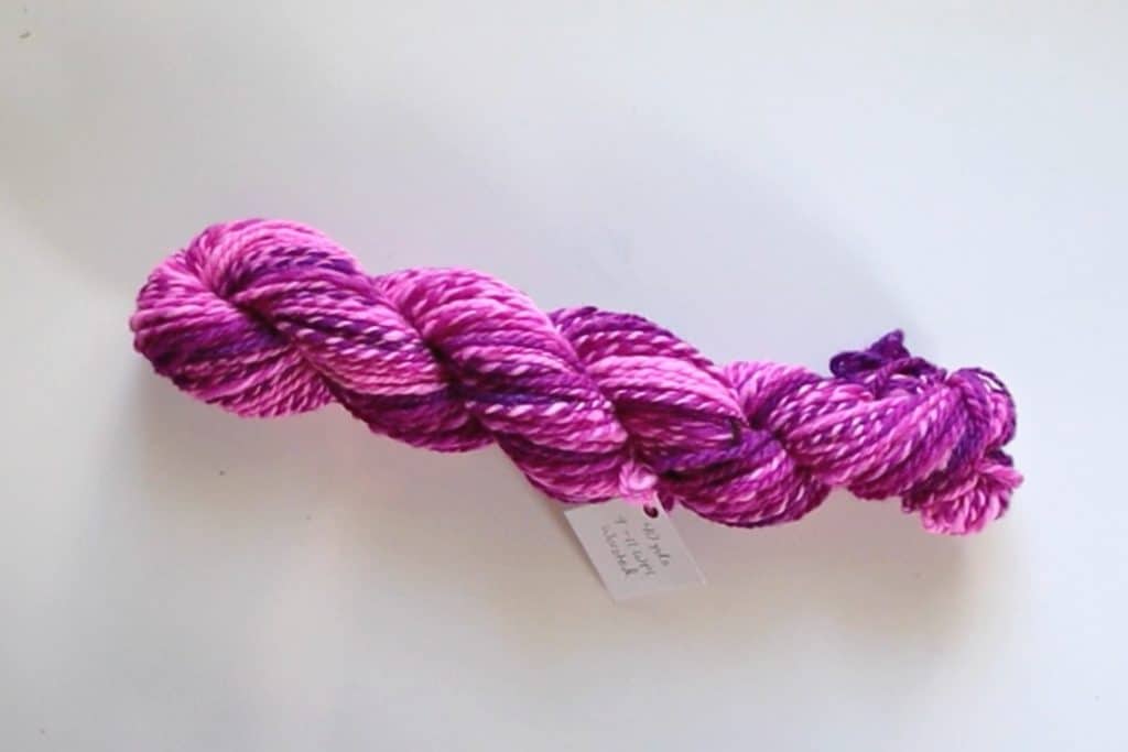 finished twisted hank of handspun pink yarn