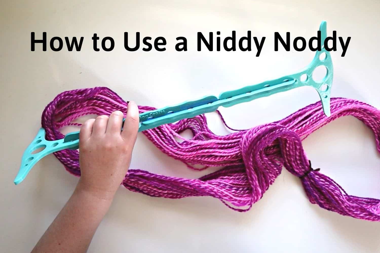 Makeshift niddy noddy I used a cardboard roll and two knitting needles.