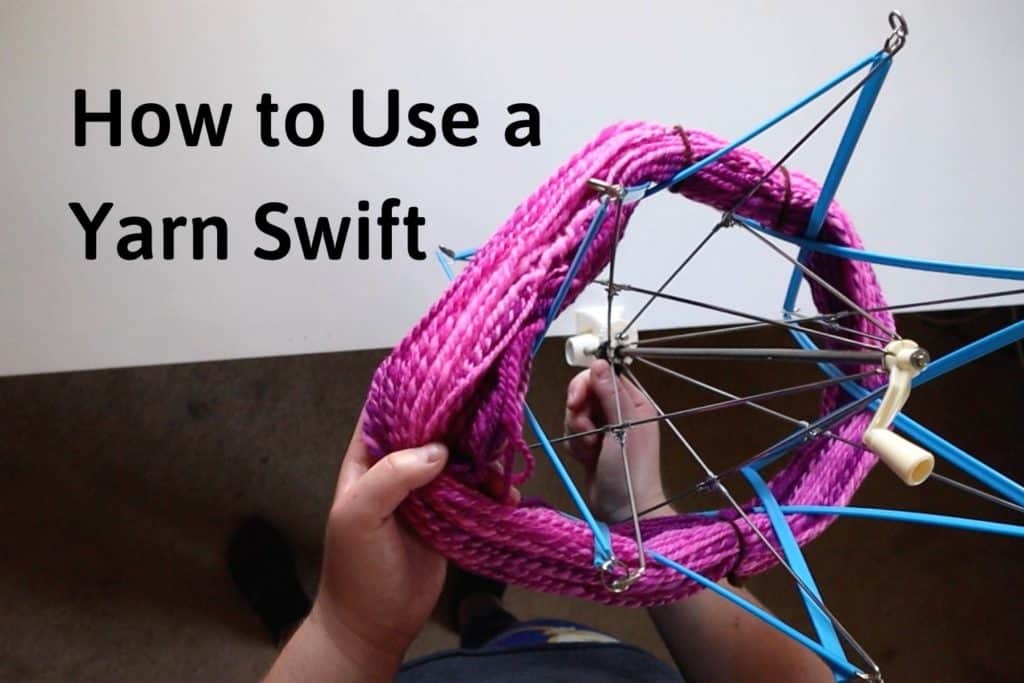 holding a hank of pink yarn and placing it onto a blue plastic yarn swift with the title "how to use a yarn swift"
