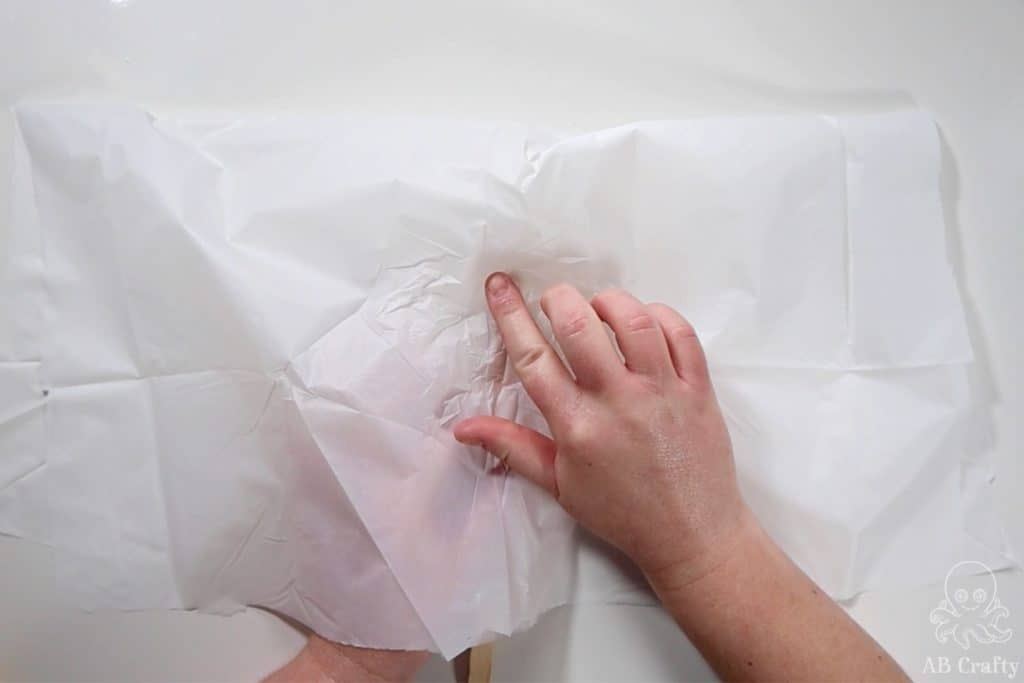 pressing the white plastic tablecloth on the outside and folded over