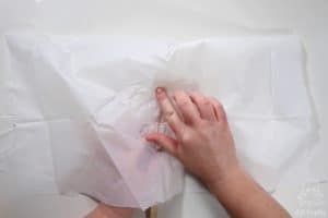 pressing the white plastic tablecloth on the outside and folded over