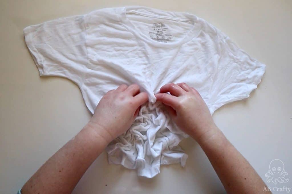 Scrunching a white cotton shirt so it crumples