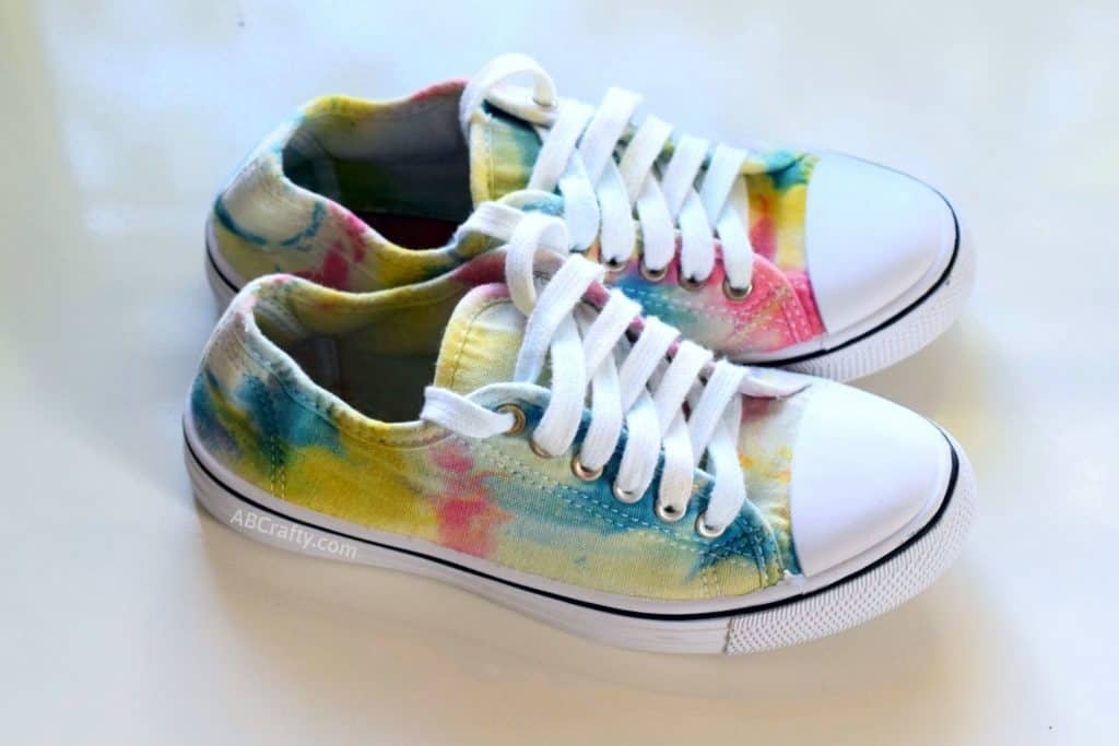 other side of finished tie dye shoes with rainbow tie dye pattern and white laces