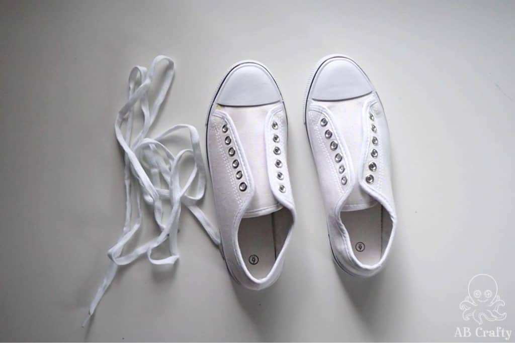 white canvas shoes or converse with the shoelaces removed and next to them