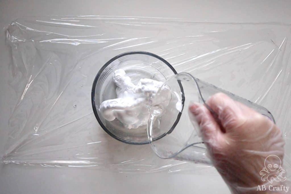 pouring water into a bowl with shaving cream