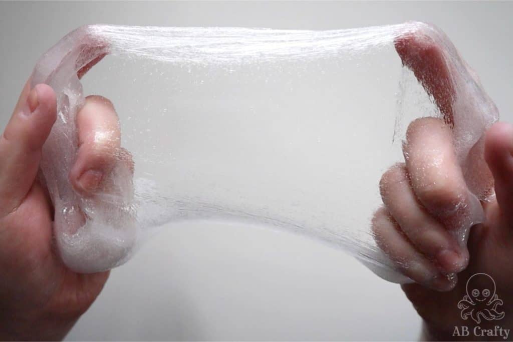 stretching clear slime with bubbles in it but showing some see through