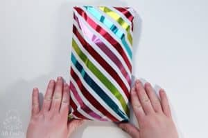 the finished wrapped present wrapped in rainbow striped wrapping paper