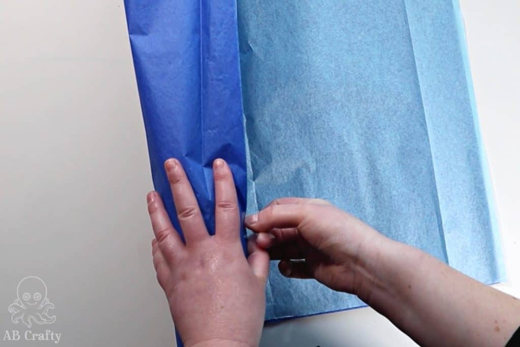 taping down blue tissue paper