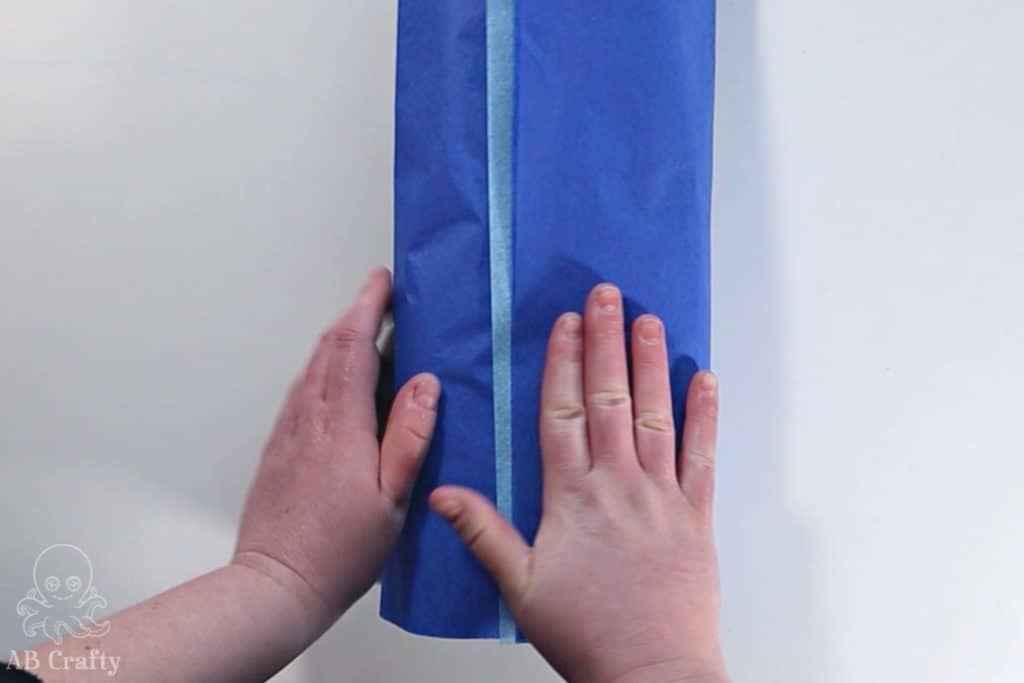 blue tissue paper wrapped around the bottle showing a light blue stripe