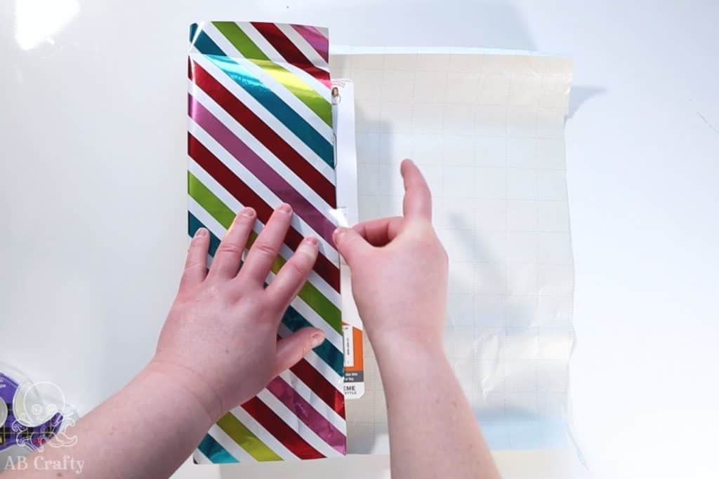 taping rainbow striped paper