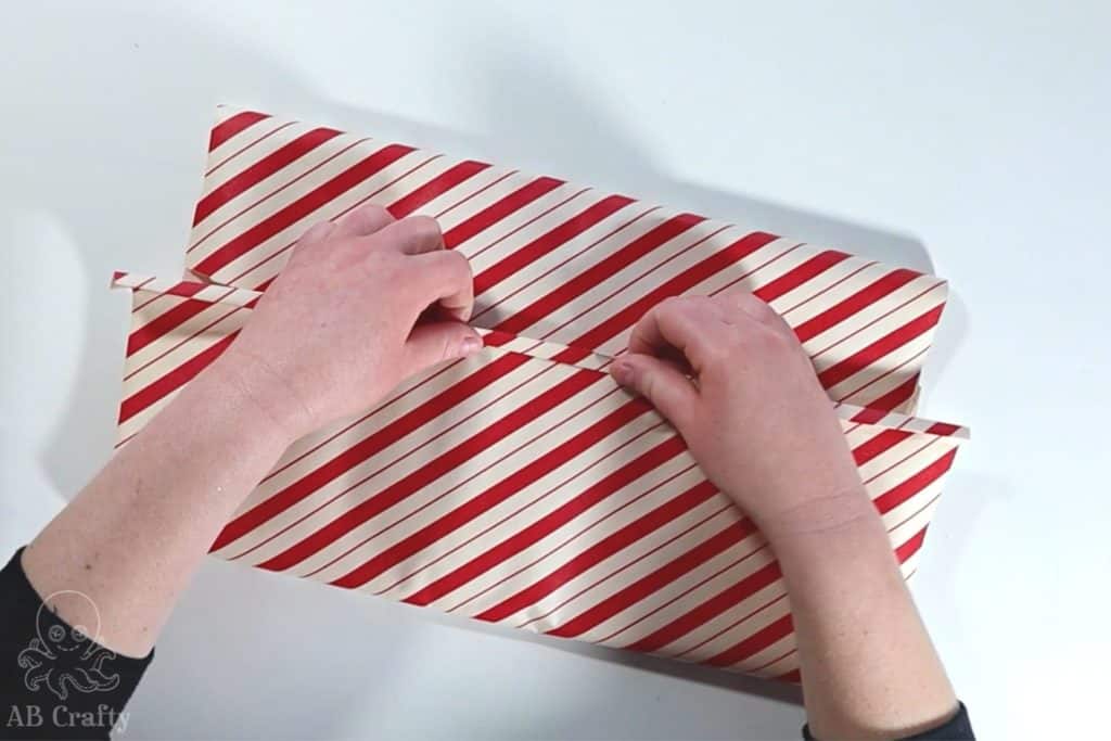 folding the wrapping paper back to form a stripe