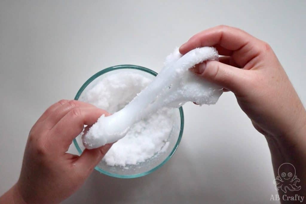 mixing instant snow into white slime
