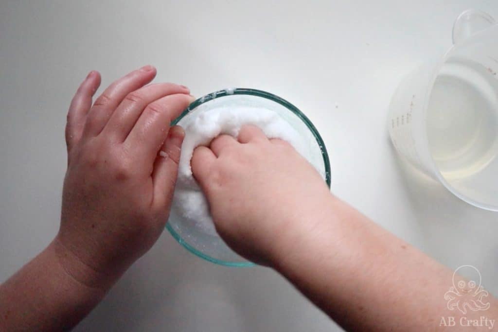 pushing slime into a bowl with instant snow