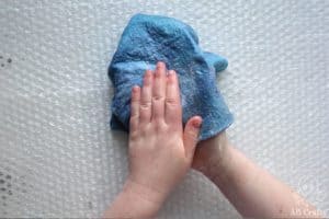 rubbing the felted wool between the palms with soapy water