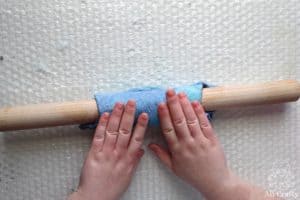 rolling the felted wool around a wooden dowel