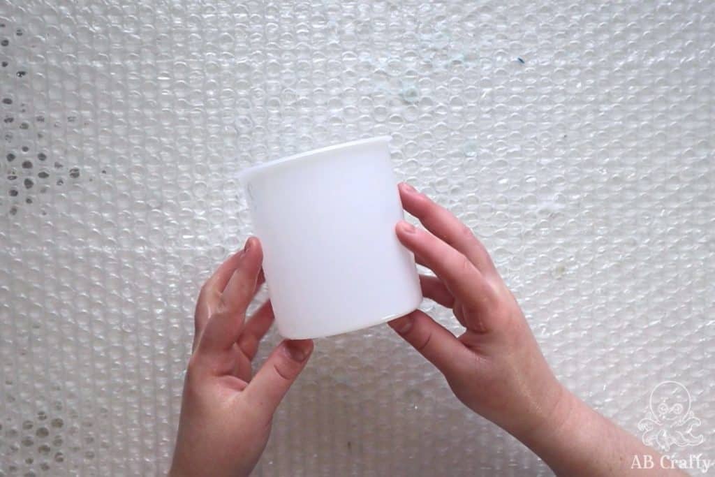 holding an empty frosting container