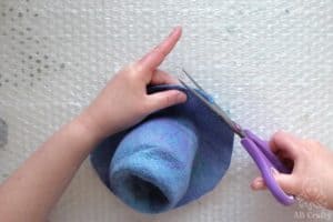 trimming the edge of the partially felted hat