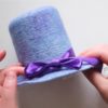 wet felted blue mini top hat with a purple bow
