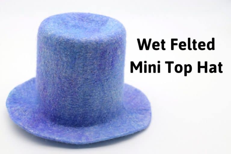 tiny blue wool hat with the title "wet felted mini top hat"