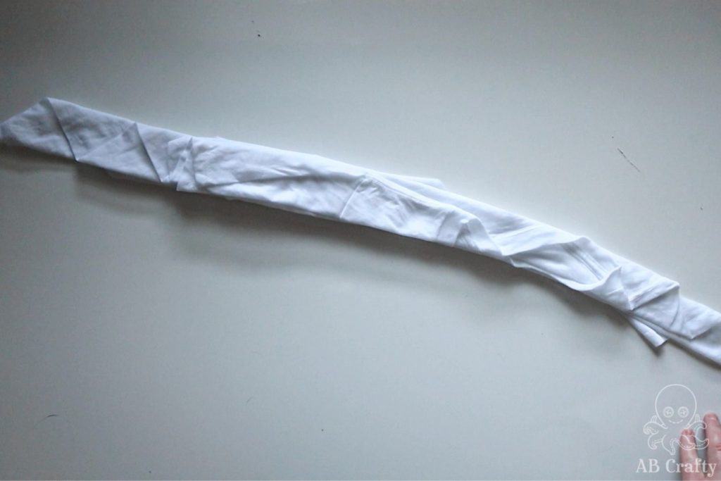 white t shirt completely folded at an angle