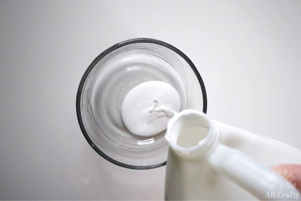 pouring white glue into a glass bowl