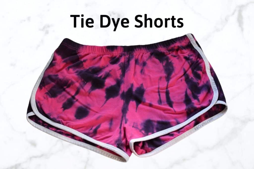 bright pink american apparel shorts with white trim dyed in a spiral design with black dye and the title says "tie dye shorts"