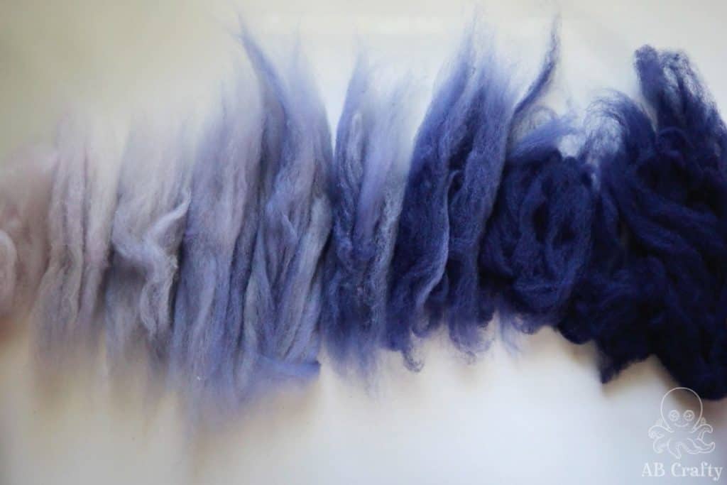 sections of hand dyed navy wool organized from lightest to darkest