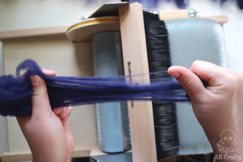 separating hand dyed dark navy wool to spread the fibers