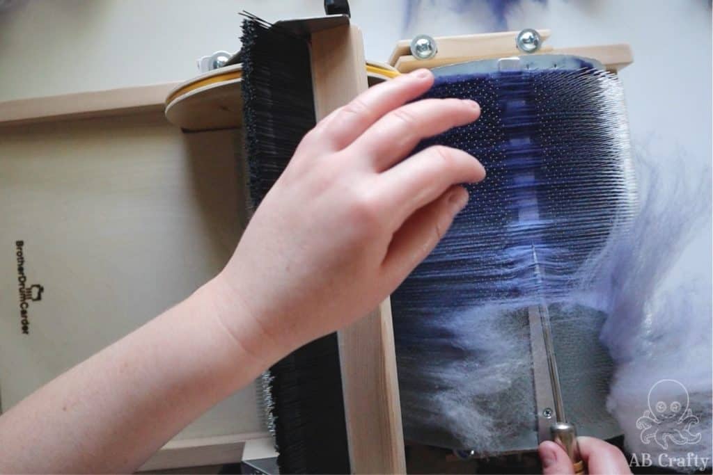 using an awl to lift the fiber off of the barrel of a brother drum carder