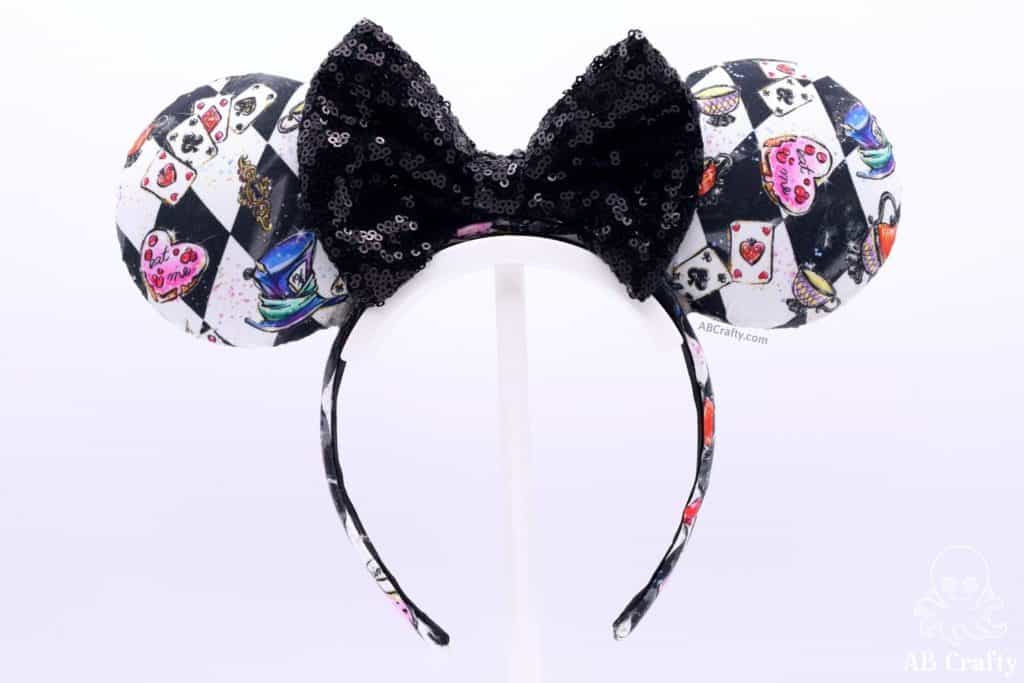 finished alice and wonderland disney ears with black sequin bow and checkerboard alice in wonderland fabric