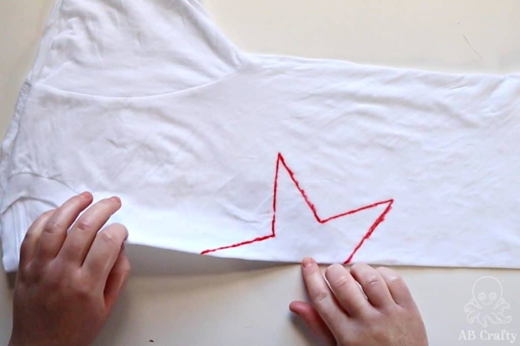 folding a white shirt with half of a red star design