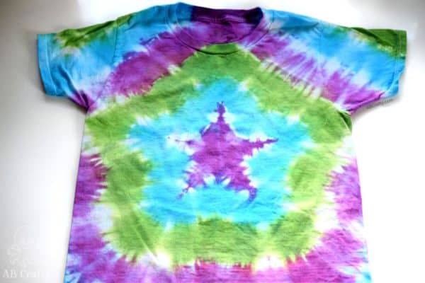 finished shirt with a star tie dye design in purple, blue, and green