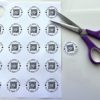 cutting out one of the qr codes from the printable buy the bride a drink venmo bracelet template