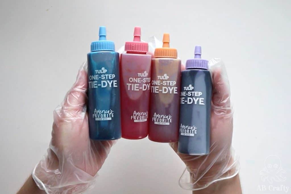 holding the tulip ombre tie dye kit's dye bottles filled with dye