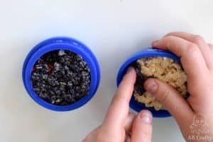 adding black rice krispie treat mixture to the top of one side of the mold and making an indent into the other