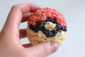 holding the finished 3d pokemon rice krispie treat in the shape of a pokeball