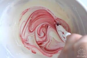 mixing red food coloring into marshmallow mixture