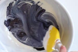 mixing black food coloring into marshmallow mixture