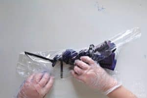 wrapping the tie dyed bucket hat with plastic wrap