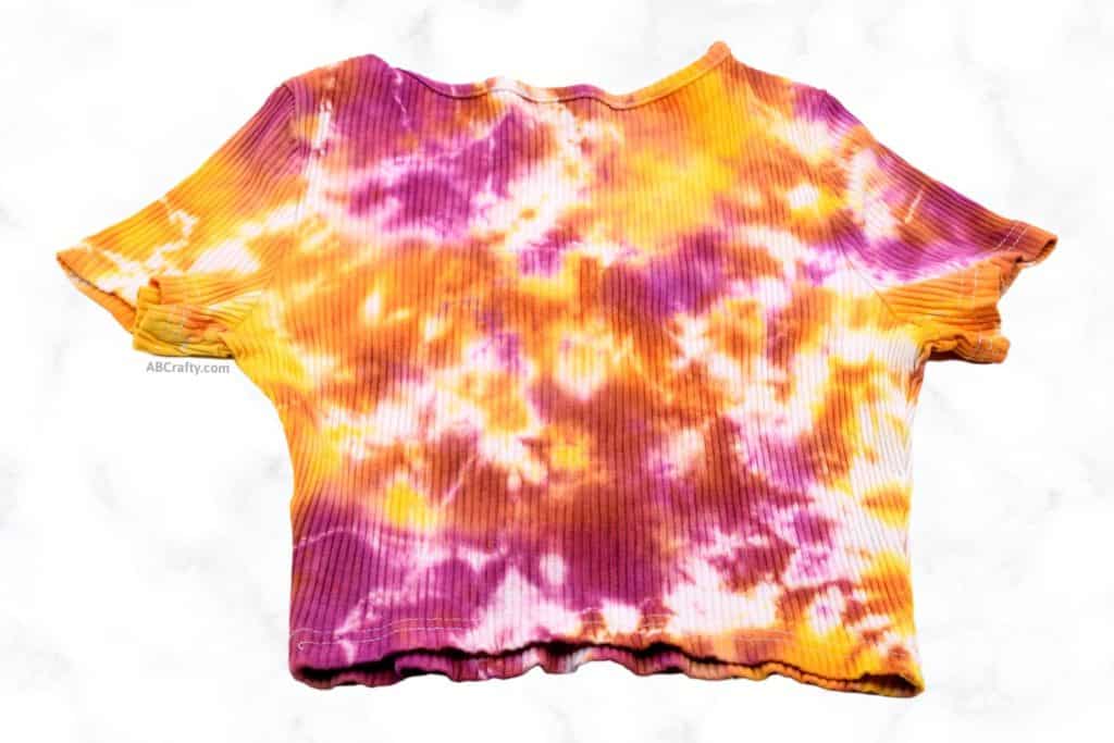back of the finished tie dye crop top with pink, orange, and yellow dye