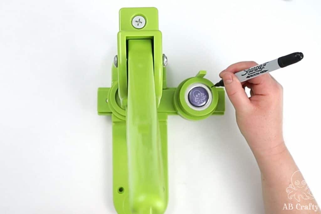 using a sharpie to mark the side of a 1 inch button machine