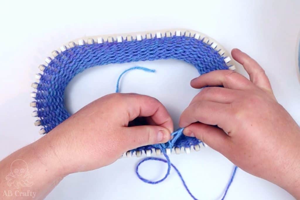 showing the second loop over the second peg on the knitting loom