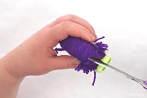 cutting the yarn with scissors down the middle