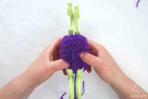 removing the halves of the pom pom maker